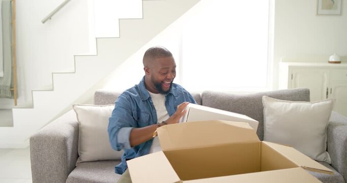 African American man opening shipping box at home pulling white box revealing order in blue tissue