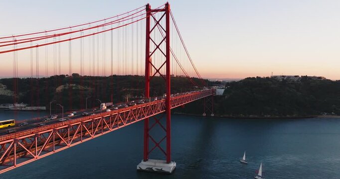 Aerial drone perspective of 25th April bridge and Lisbon shoreline
