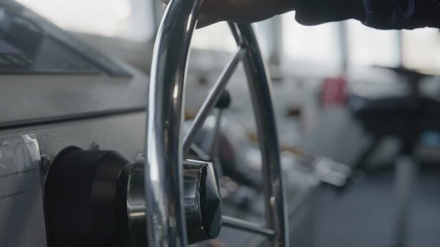 Hand on the wheel steering a big ship