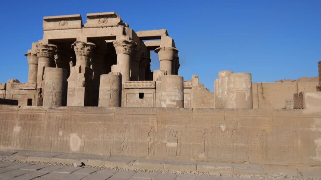Kom Ombo temple ruins with double columns and composite capitals against clear blue sky in Egypt