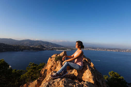 woman sitting on a rock