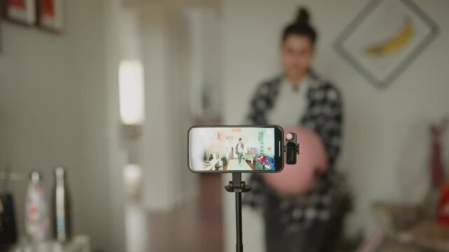 Recording personal vlog with casual attire and comfortable decor