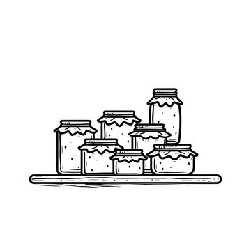 Glass jars of preserves stacked on wooden shelf in kitchen  