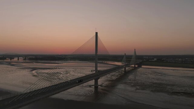 Liverpool, Merseyside, UK, June 19, 2025; Aerial 4K video footage of the Mersey Gateway toll bridge with stunning views over the River Mersey, Liverpool, UK.