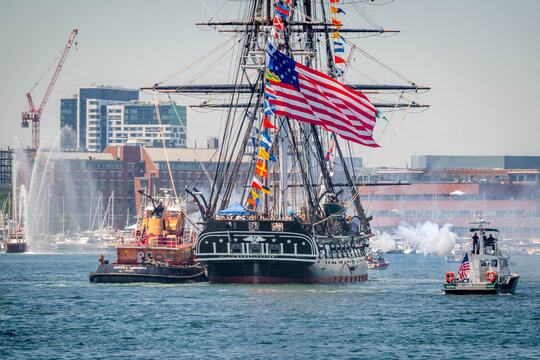 The USS Constitution fires its cannons in Boston Harbor