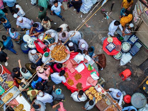 Dhaka, Bangladesh - 01 March 2026: Aerial view of a bustling Chawkbazar market comes alive, a vibrant tapestry of food, colors, and people, a sensory feast under the open sky.