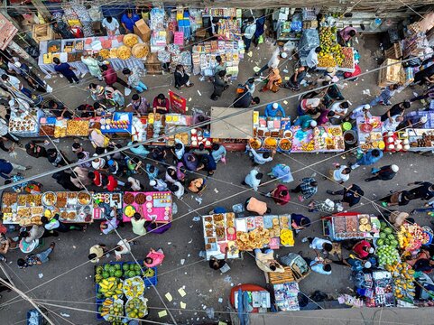 Dhaka, Bangladesh - 01 March 2026: Aerial view of Chawkbazar's bustling marketplace, vibrant with colorful displays of food and eager shoppers creating a lively tapestry.