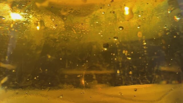 Close up of glass of beer dring with bubbles