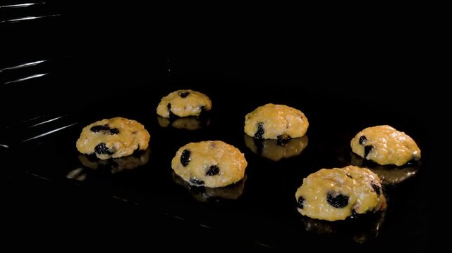 Timelapse - process of cooking six homemade crunchy oatmeal cookies in row on metal sheet in oven - close up view. Time lapse, dessert, cookery, baking, gastronomy and food concept