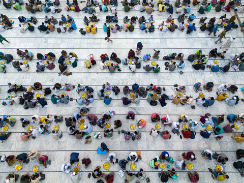 Dhaka, Bangladesh - 03 March 2026: Aerial view of devotees gathered at the National Mosque, a tapestry of colorful clothing against the stark white marble floors.