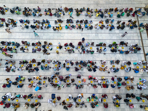 Dhaka, Bangladesh - 03 March 2026: Aerial view of worshippers arranged in neat rows at the National Mosque, their colorful clothing a vibrant contrast against the plain, light-colored floor.