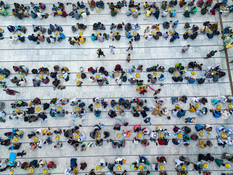 Dhaka, Bangladesh - 03 March 2026: Aerial view of the Baitul Mukarram National Mosque, where hundreds gather in orderly rows, their colorful attire contrasting against the mosque's geometric patterns.