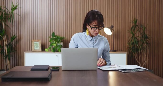 Reading, paperwork and woman with laptop in office, application evaluation and bank loan processing. Funding eligibility, pc or mature credit analyst with online screening, request status or approval