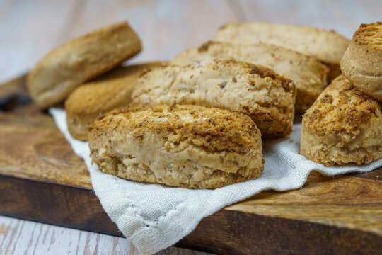 Polvorones and mantecados, traditional Christmas cakes from Andalusia, Spain, on wooden background, view from above. Copy space