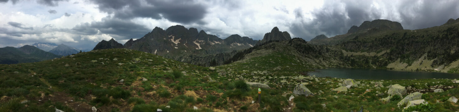 Pyrenees mountain lake with moody clouds