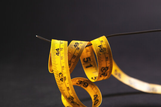 measuring tape isolated on black background with copyspace
