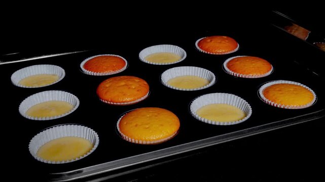 Cinemagraph, loop - twelve cupcakes, muffins baking and rising alternately in muffin tin in electric oven at home - timelapse. Homemade bakery, food, cooking, pastry and time lapse concept