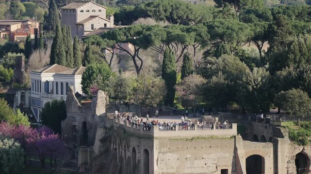 Aerial shot of crowd of tourist people visiting Romen forum at Terrazza Belvedere del Palatino in Rome, Italy