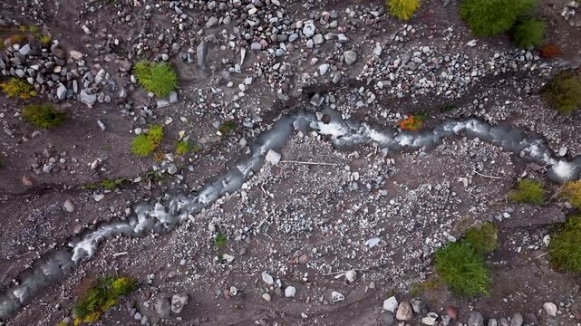 Aerial drone clip over and evergreen forest and river in the American West.