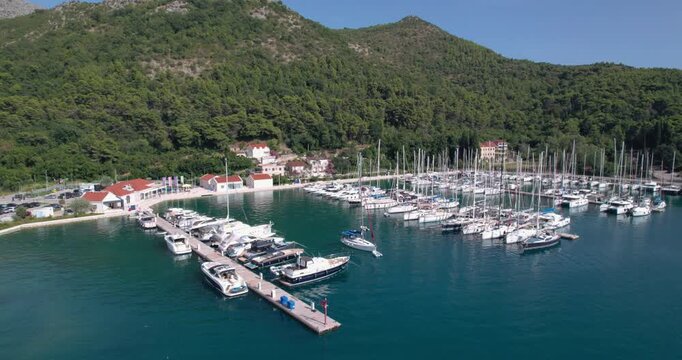 Marina With Yachts. Vibrant Harbor Scene With Boats. Busy Port Filled With Moored Sailing Vessels. Lively Marina Bustling With Docked Yachts And Crew Activities
