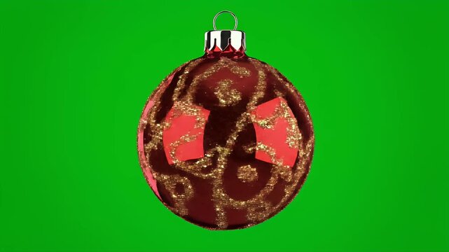 A dark red, sparkling Christmas ornament with gold patterns and red inlays