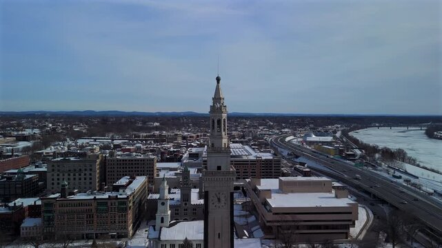 Drone aerial of snowy Springfield Massachusetts skyline and river