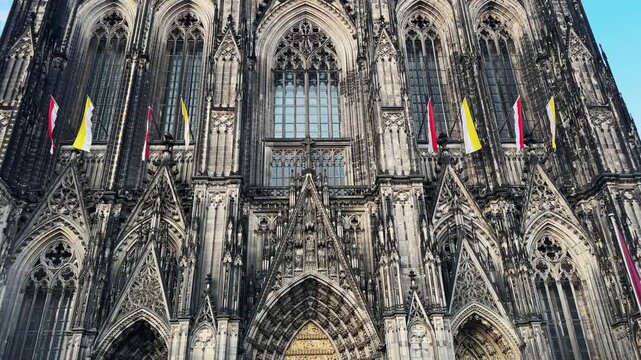 Cologne Dom cathedral seen from below with blue sky. Cologne Cathedral, or Kolner Dom, is the main landmark of Cologne and a catholic church in Germany.