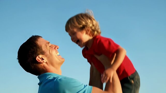 Happy father lifting laughing young son in air