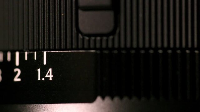 Macro shot of a mirrorless camera lens aperture ring changing from f/1.4 through to f/16.