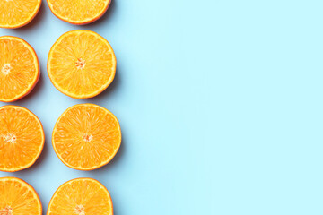 Fototapeta premium Fresh juicy tangerines on light blue background, flat lay. Space for text