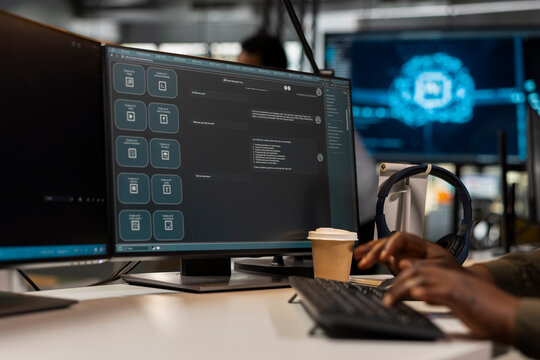 Close up of programmer at work solving tasks with AI LLM chatbot answering prompts using predictive tech. Startup IT specialist using computer to interact with large language model application