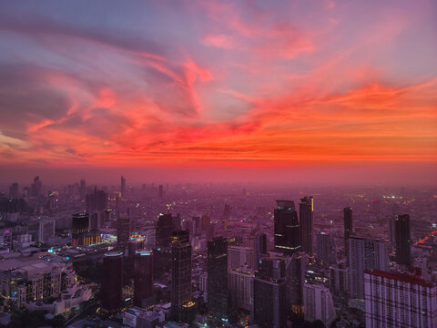 Beautiful sunset at dense urban area of Bangkok from King Power Mahanakhon skywalk, Thailand