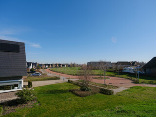 Birds-eye perspective of Dutch suburban development with mixed housing and red cycling network