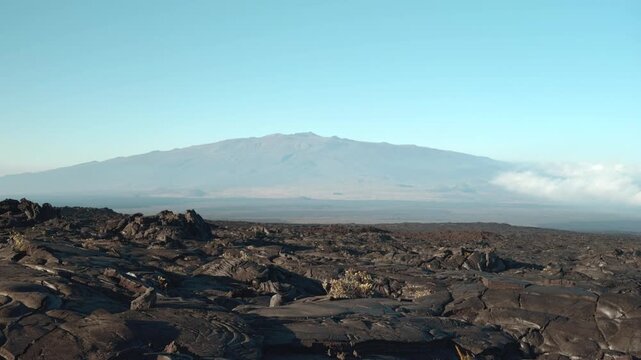 Tholeiitic basalt Lava flows (Kau Basalt) from Earth's largest active volcano Mauna Loa (Shield volcano). Pu'u Huluhulu, The Big Island (Hawaiʻi Island). Mauna Kea is in the distance.

