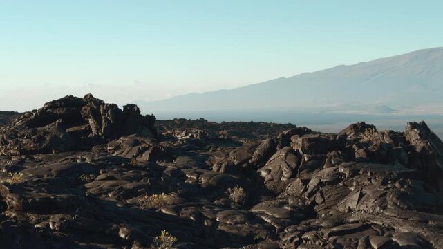 Tholeiitic basalt Lava flows (Kau Basalt) from Earth's largest active volcano Mauna Loa (Shield volcano). Pu'u Huluhulu, The Big Island (Hawaiʻi Island). Mauna Kea is in the distance.

