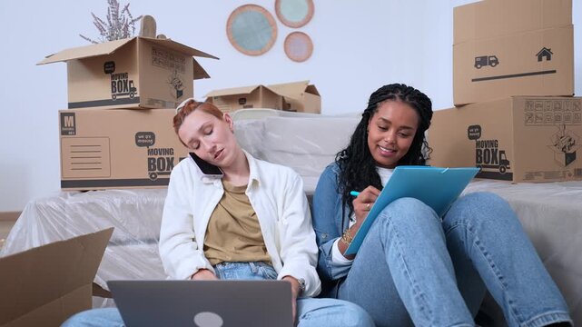 Two women planning their move to a new apartment