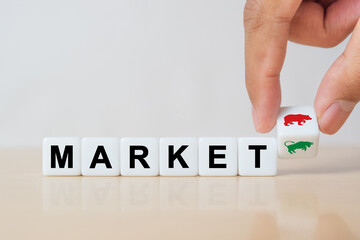 Symbol for a trend change at the stock market. Hand turns a dice and changes the symbol of a bear...