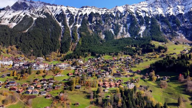Wengen village aerial view situated on a mountain shelf with majestic alpine backdrop. Wengen, Canton of Bern, Switzerland