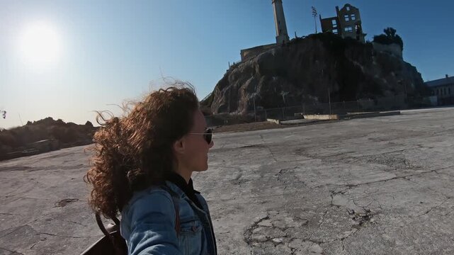 Selfie of female tourist woman visiting the Alcatraz Island in San Francisco. The Alcatraz island was a federal prison from 1933 until 1963.