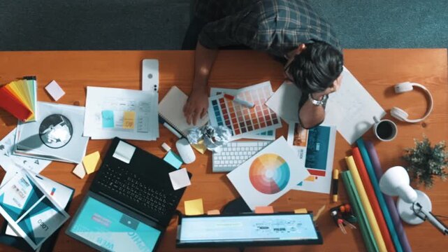 Top down view of designer work on palettes and crumpled paper. Top view of skilled business man run out of idea while sleeping at meeting table. Project manager crumpled and throw paper. Symposium.