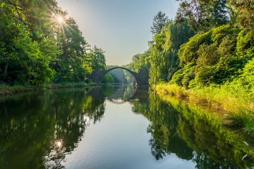 Keuken achterwand Rakotzbrücke Rakotz Bridge with sunrise flare (Rakotzbrucke, Devil's Bridge) in Kromlau, Saxony, Germany  © Pawel Pajor