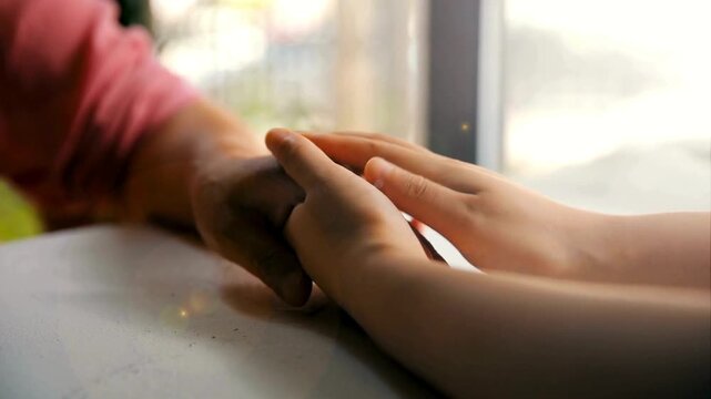 elderly man and woman holding hands together for unity, respect and compassion. unrecognizable romantic couple holding hands. concept of trust and love.