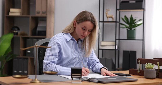 Notary working at wooden desk in office