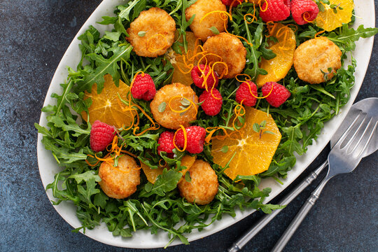 Fried goat cheese and arugula salad with orange and raspberry