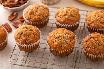 Banana muffins with pecan nuts freshly baked on a cooling rack