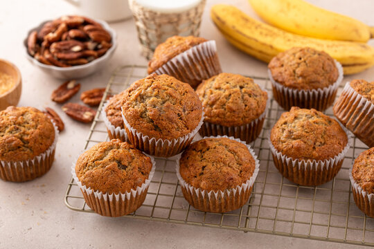 Banana muffins with pecan nuts freshly baked on a cooling rack