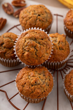 Banana muffins with pecan nuts freshly baked on a cooling rack