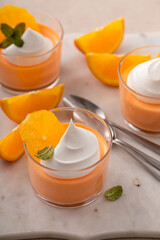 Orange yogurt parfait with whipped cream topping, high protein dessert