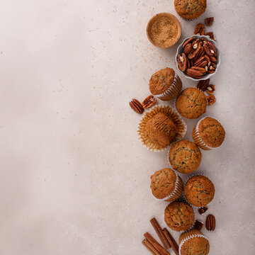 Banana muffins with pecan nuts freshly baked on a cooling rack overhead with copy space