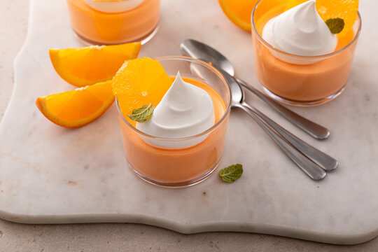 Orange yogurt parfait with whipped cream topping, high protein dessert